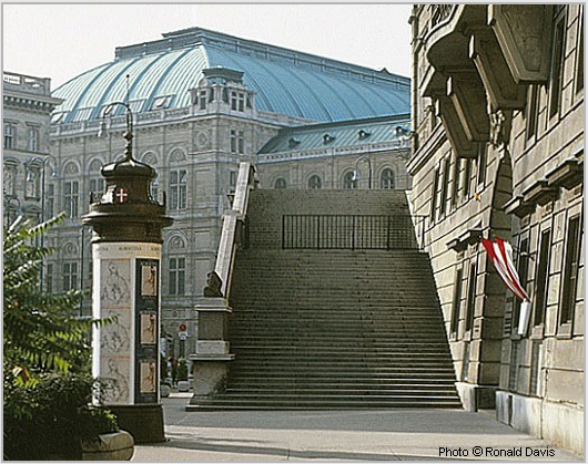 Entrance to the Albertina (right), Vienna. Column with posters announcing the museum's exhibitions "Raphael in der Albertina," and "Stanley Roseman - Zeichnungen aus Klostern," 1983. Photo © Ronald Davis
